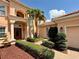 Elegant home showcasing well-manicured landscaping, a fountain, and a beautiful brick entryway at 4120 Juliana Lake Dr, Auburndale, FL 33823