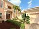 Charming two-story home with well-manicured landscaping, a fountain, and attached garage at 4120 Juliana Lake Dr, Auburndale, FL 33823
