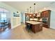 Spacious kitchen boasts an island with seating, stainless appliances, and dark wood cabinets at 4120 Juliana Lake Dr, Auburndale, FL 33823