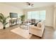 Cozy living room features neutral furniture, large window, and decor at 4120 Juliana Lake Dr, Auburndale, FL 33823