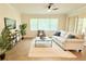 Comfortable living room with large windows, ceiling fan, and neutral decor at 4120 Juliana Lake Dr, Auburndale, FL 33823