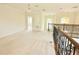 Spacious upstairs loft area with carpeted floors and decorative wrought iron railing at 4120 Juliana Lake Dr, Auburndale, FL 33823
