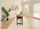 Bright home office space with a desk, white rug, and natural light from a window and glass door at 4120 Juliana Lake Dr, Auburndale, FL 33823
