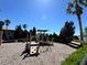 Outdoor playground surrounded by lush landscaping featuring slides, climbing structures, and a wood chip ground cover at 4120 Juliana Lake Dr, Auburndale, FL 33823