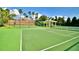 Community tennis and basketball courts, surrounded by lush landscaping and mature trees at 4120 Juliana Lake Dr, Auburndale, FL 33823