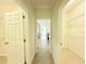Hallway leading to walk-in closet featuring wire shelving for storage at 4120 Juliana Lake Dr, Auburndale, FL 33823