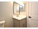 Bathroom vanity with gray cabinet, mirror, and quartz countertop at 4404 Gwyndale Ct, Orlando, FL 32837