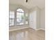 Light-filled bedroom with wood-look tile flooring and a large window at 4404 Gwyndale Ct, Orlando, FL 32837