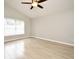 Light filled bedroom showcasing wood-look flooring and a ceiling fan fixture with integrated lighting at 4404 Gwyndale Ct, Orlando, FL 32837