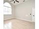 Bedroom with tile floors, arched window, ceiling fan, and neutral gray paint at 4404 Gwyndale Ct, Orlando, FL 32837