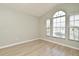 Bright bedroom featuring wood-look tile floors and a large arched window at 4404 Gwyndale Ct, Orlando, FL 32837