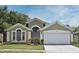Charming single-Gathering home showcases a well-manicured lawn and an attached two-car garage at 4404 Gwyndale Ct, Orlando, FL 32837