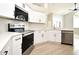 Modern kitchen features stainless steel appliances, white cabinets, and stone countertops at 4404 Gwyndale Ct, Orlando, FL 32837