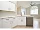 Modern kitchen features stainless steel appliances, white cabinets, and stone countertops at 4404 Gwyndale Ct, Orlando, FL 32837