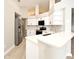 Bright kitchen features white cabinets, stainless steel appliances, and a breakfast bar at 4404 Gwyndale Ct, Orlando, FL 32837