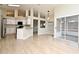 Open concept living room with a full kitchen, tile floors, and sliding glass doors at 4404 Gwyndale Ct, Orlando, FL 32837