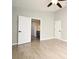 Primary bedroom with wood-look flooring and doorway view into an en suite bathroom at 4404 Gwyndale Ct, Orlando, FL 32837