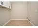 Utility room featuring wood-look vinyl flooring and overhead cabinets for storage at 4404 Gwyndale Ct, Orlando, FL 32837