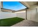 Backyard featuring an artificial turf area and brick patio at 5089 Caspian St, St Cloud, FL 34771