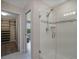 Modern bathroom featuring glass enclosed shower with tiled walls, and a glimpse of the walk in closet at 5089 Caspian St, St Cloud, FL 34771