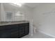 Bathroom featuring double vanity with granite countertop, toilet, and shower area with tiled walls at 5089 Caspian St, St Cloud, FL 34771