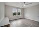 Bright bedroom features wood floors, a ceiling fan, and a modern floating cabinet at 5089 Caspian St, St Cloud, FL 34771