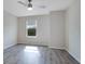 The bedroom features a ceiling fan, wood-look flooring, and a bright window at 5089 Caspian St, St Cloud, FL 34771