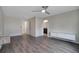 Large bedroom with wood flooring, a ceiling fan, attached bathrooms, and modern floating cabinets at 5089 Caspian St, St Cloud, FL 34771