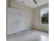 Bedroom featuring tile floors, two closets, and a window letting in lots of natural light at 5089 Caspian St, St Cloud, FL 34771