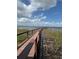 Wooden dock extending into a tranquil lake, surrounded by lush reeds and foliage at 5089 Caspian St, St Cloud, FL 34771