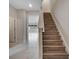 Inviting entryway with wood stairs and easy access to the first floor at 5089 Caspian St, St Cloud, FL 34771