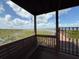 Enclosed gazebo seating area overlooking a lake, providing a serene view at 5089 Caspian St, St Cloud, FL 34771