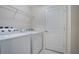 Laundry room featuring white washer and dryer, wire shelf and a white door at 5089 Caspian St, St Cloud, FL 34771