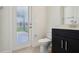 Half bath with a black vanity and granite countertop, and exterior access door at 5260 Citrus Leaf Blvd, Winter Garden, FL 34787