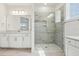 Bright bathroom featuring a glass shower, neutral tile, and a white vanity with ample counter space at 5260 Citrus Leaf Blvd, Winter Garden, FL 34787