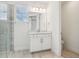 Neutral bathroom featuring a glass shower, large mirror, and white vanity with storage at 5260 Citrus Leaf Blvd, Winter Garden, FL 34787