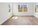 Bright bedroom with hardwood floors and large windows providing plenty of natural light at 5260 Citrus Leaf Blvd, Winter Garden, FL 34787