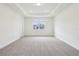 Spacious bedroom features tray ceiling and window with neighborhood view at 5260 Citrus Leaf Blvd, Winter Garden, FL 34787