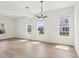 Sunlit dining area showcasing hardwood floors, large windows, and views of the neighborhood at 5260 Citrus Leaf Blvd, Winter Garden, FL 34787