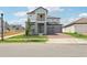 Two-story home featuring a gray exterior, balcony, brick driveway, and attached two-car garage at 5260 Citrus Leaf Blvd, Winter Garden, FL 34787