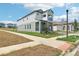 A charming two-story home featuring a two-car garage, a balcony, and an adjacent lawn at 5260 Citrus Leaf Blvd, Winter Garden, FL 34787