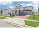Two-story home showcasing a two-car garage, a cozy balcony, and landscaped front lawn at 5260 Citrus Leaf Blvd, Winter Garden, FL 34787