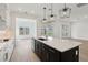Modern kitchen features a large black island with a light countertop, and modern stainless appliances at 5260 Citrus Leaf Blvd, Winter Garden, FL 34787