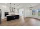 Modern kitchen features a large black island with a light countertop, and black pendant lighting at 5260 Citrus Leaf Blvd, Winter Garden, FL 34787
