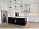 Modern kitchen featuring white cabinetry, a black island, and stainless steel appliances at 5260 Citrus Leaf Blvd, Winter Garden, FL 34787