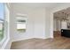 Bright living room area showcasing hardwood floors and open access to other rooms at 5260 Citrus Leaf Blvd, Winter Garden, FL 34787