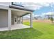 A covered patio with gray pillars overlooks a grassy yard and neighborhood homes at 5260 Citrus Leaf Blvd, Winter Garden, FL 34787