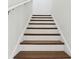 Stairway with white risers and wooden treads leading to the upper level at 5260 Citrus Leaf Blvd, Winter Garden, FL 34787