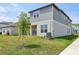 Well-maintained backyard with lush grass and a young tree, showcasing the home's exterior at 5278 Citrus Leaf Blvd, Winter Garden, FL 34787