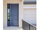 Inviting front entry featuring a stylish blue door, sleek hardware, and convenient electronic lock at 5278 Citrus Leaf Blvd, Winter Garden, FL 34787